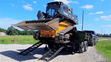 loading skid steer on dump truck|skid steer in dump trailer.